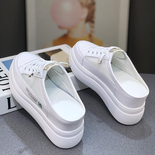 White sneakers on a gray surface with a blurred background | Koalakits36